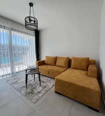 a living room with a couch and a table at Modern Seaside Studio at Northern Cyprus - Pearl Island in Pyla