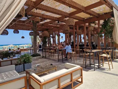 a restaurant with tables and chairs under a wooden pavilion at Grand Sapphire 22 floor B BLock 377, Cypr Północny in Paralimni