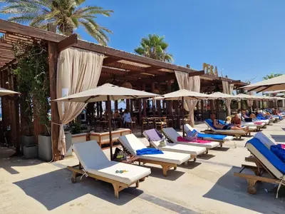 a row of lounge chairs and umbrellas at a resort at Grand Sapphire 22 floor B BLock 377, Cypr Północny in Paralimni