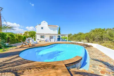 a villa with a swimming pool in front of a house at Villa Marilena in Protaras