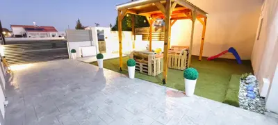 a backyard with a playground with potted plants on a house at Light garden in Limassol