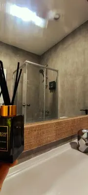 a bathroom with a shower with a glass door at Light garden in Limassol