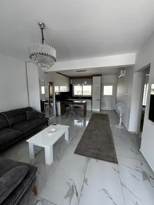 a living room with a couch and a table at Apartman Severny Cyprus in Iskele