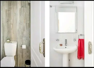 a bathroom with a white toilet and a sink at Amazing Sea View -3 Bed Ground Floor Garden Apartment in Kérynia