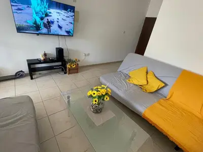 a living room with a couch and a glass table at Sunflower Oroklini in Voroklini