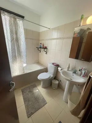 a bathroom with a toilet and a sink at Sunflower Oroklini in Voroklini