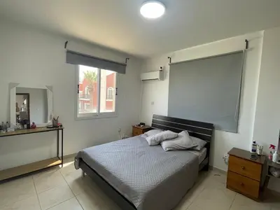 a bedroom with a bed and a large screen at Sunflower Oroklini in Voroklini