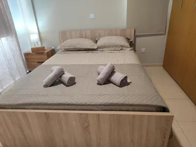 two pillows on a bed in a bedroom at Julia Holiday Apartment in Larnaka