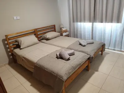 two beds in a bedroom with two pillows on them at Julia Holiday Apartment in Larnaka