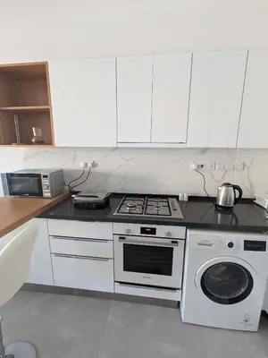 a kitchen with a stove and a washing machine at Caesar Blue Studio Sea View Apartment in Boğaz