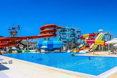 a pool with a water park with slides at Caesar Blue Studio Sea View Apartment in Boğaz
