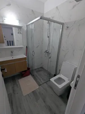 a bathroom with a shower and a toilet and a sink at Caesar Blue Studio Sea View Apartment in Boğaz