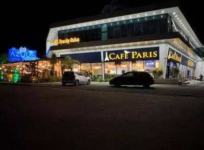 two cars parked in front of a building at night at Caesar Blue Studio Sea View Apartment in Boğaz