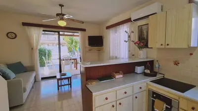 a kitchen and living room with a couch and a table at STAY Sea Gem Apartment in Meneou