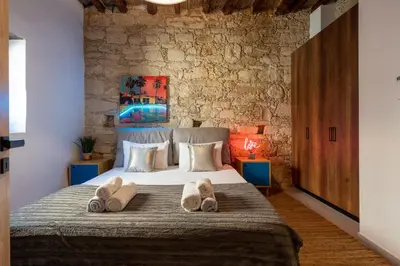 a bedroom with a bed with two towels on it at Exquisite 2BR modern village house w private pool in Ayios Tykhonas
