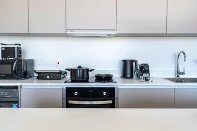 a kitchen with a stove and a sink at Blu Horizon - Stylish Living with Pool & Balconies in Protaras in Paralimni