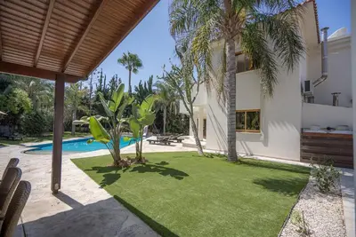 an external view of a villa with a swimming pool at Blue Pearl Villa - 6 Bedroom in Pyla