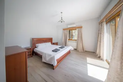 a bedroom with a bed and a dresser and a window at Blue Pearl Villa - 6 Bedroom in Pyla