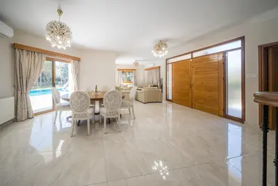 a dining room with a table and chairs at Blue Pearl Villa - 6 Bedroom in Pyla