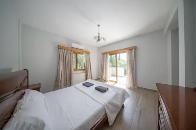 a bedroom with a bed with two towels on it at Blue Pearl Villa - 6 Bedroom in Pyla