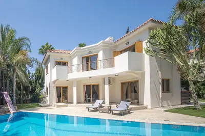 a large villa with a swimming pool in front of it at Blue Pearl Villa - 6 Bedroom in Pyla