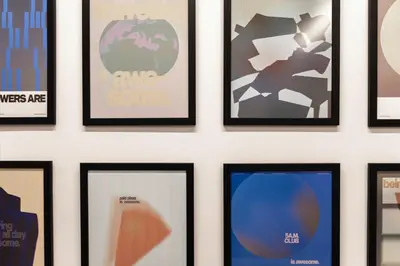 a group of framed posters on a wall at Aweso Limassol in Limassol