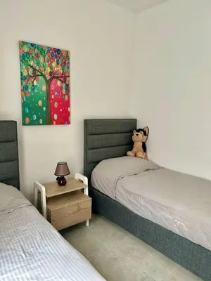 a teddy bear sitting on a bed in a bedroom at Terra Vista in Kérynia