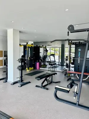 a gym with several treadmills and machines in it at Terra Vista in Kérynia