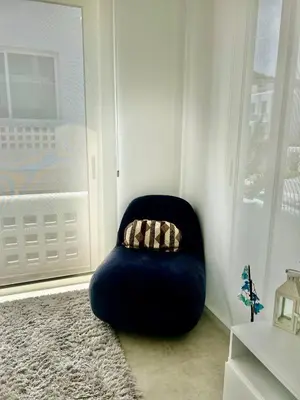 a black chair with a pillow in a room at Terra Vista in Kérynia