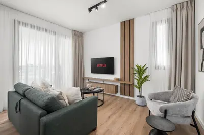 a living room with a couch and a tv at Artemis 202 - Seaside Stories in Livadhia