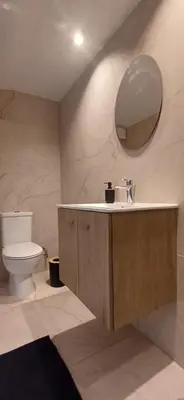 a bathroom with a sink and a toilet and a mirror at Jay's Nest in Larnaka