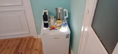 a counter with various kitchen items on top of a refrigerator at Jay's Nest in Larnaka