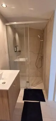a bathroom with a shower with a glass door at Jay's Nest in Larnaka