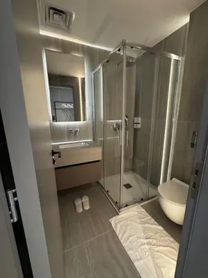 a bathroom with a shower and a sink and a toilet at AppleGym sports centre in Laxia