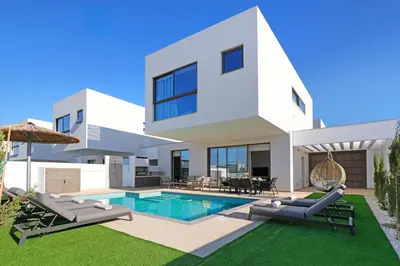 a white house with a swimming pool and lawn at Princess Anne Luxury Villa - Large Pool in Protaras