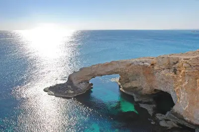 an arch in the rocks in the ocean at Princess Anne Luxury Villa - Large Pool in Protaras