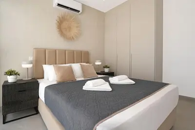 a bedroom with a large bed with two towels on it at Princess Zena Luxury Villa - Large Pool in Protaras