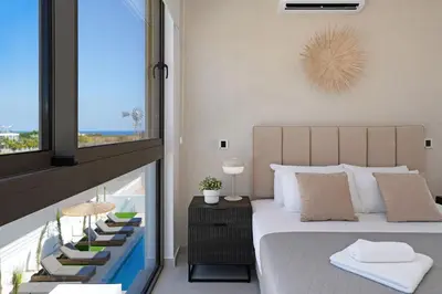 a bedroom with a large bed and a balcony at Princess Zena Luxury Villa - Large Pool in Protaras