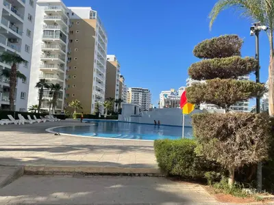 a swimming pool in the middle of a city at Family friendly modern flat in Caesar Resort &SPA, Long Beach İSKELE, KKTC in Iskele