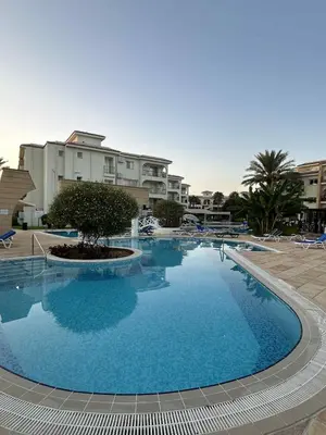 a large blue pool with a tree in the middle at Sunrise Beach Club, Bogaz, North Cyprus in Boğaz