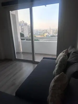 a bedroom with a bed and a large window at Faneromeni 33 in Scala
