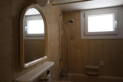 a bathroom with a shower and a sink and a mirror at Beach Front Apartment in Limassol