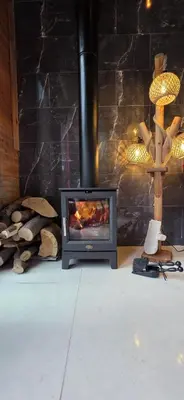 a fireplace in a room with a stone wall at Chardonnay Tiny Home for Nature Lovers North Cyprus in Kérynia