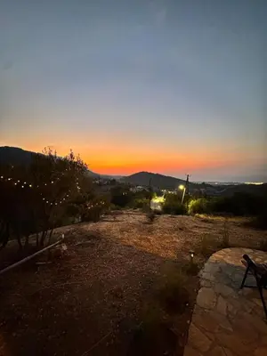 a view of a sunset from a field with a bench at Chardonnay Tiny Home for Nature Lovers North Cyprus in Kérynia
