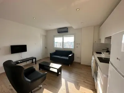 a living room with a couch and a table at Premium City Center 10th Floor Sky View -Suite 103 in Nicosia