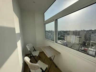 a room with two chairs and a table and a large window at Premium City Center 10th Floor Sky View -Suite 103 in Nicosia