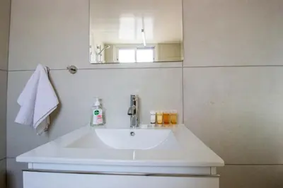 a white sink in a bathroom with a mirror at Sea View Stay 200m to Beach in Voroklini