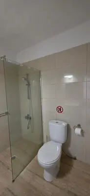 a bathroom with a toilet and a glass shower at CrisMari Napa in Ayia Napa