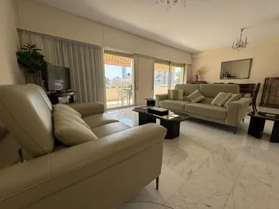 a living room with two couches and a television at Sfina Sea view apartment by Ezoria villas in Limassol