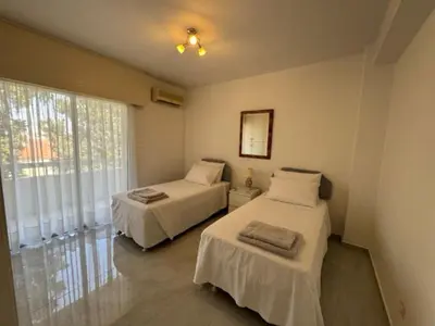 a bedroom with two beds and a window at Sfina Sea view apartment by Ezoria villas in Limassol